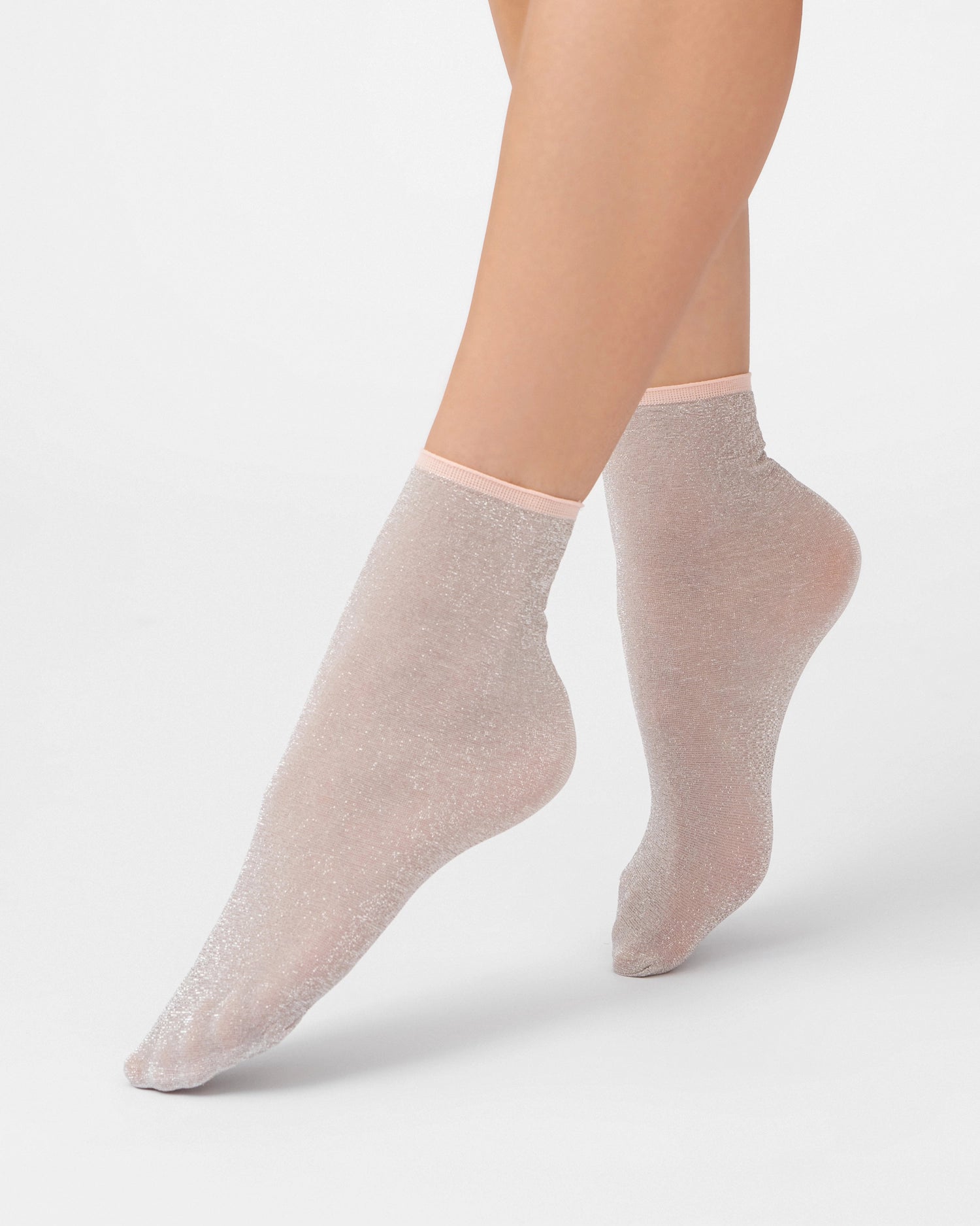 Ohdita shimmer glitter socks. Lightweight pink ankle socks for women. Chic fashion socks for elevated casual outfits and dressy outfits. Pairs well with dresses, skirts, and pants as well as with heels, loafers and sneakers.