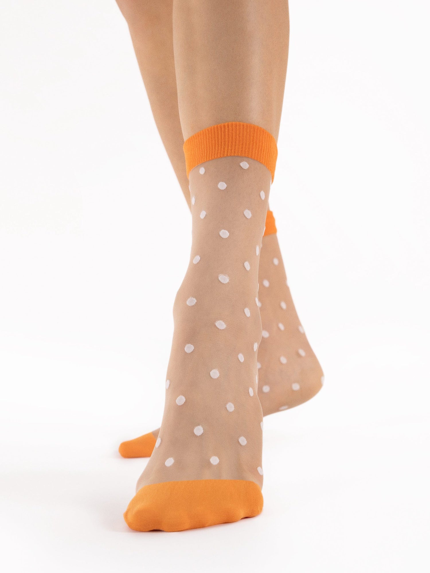 Fancy sheer polka dot socks for women with white polka dot pattern and orange cuffs and toes