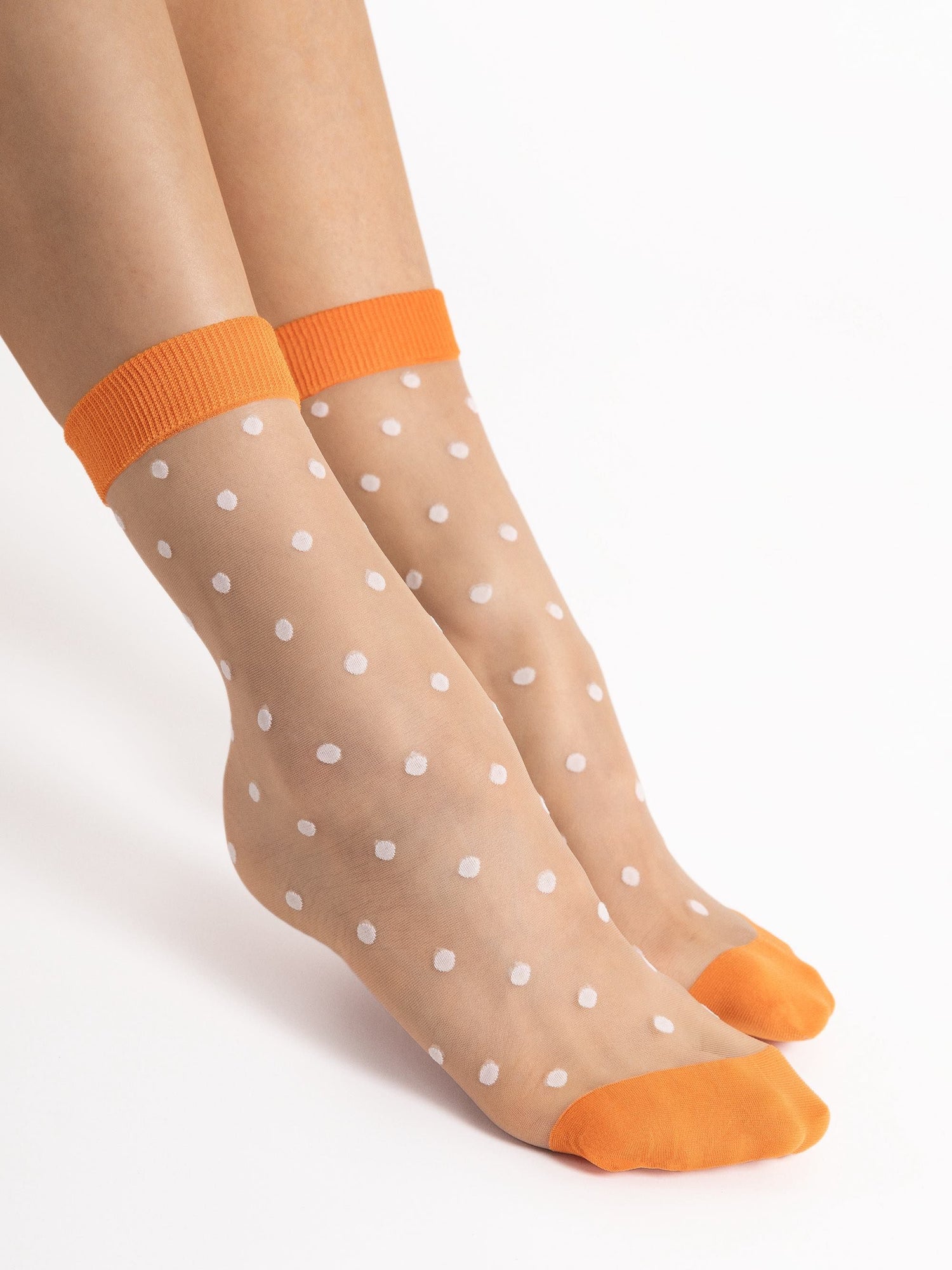 Fashion sheer ankle socks for women with orange cuffs and toes, and white polka dots