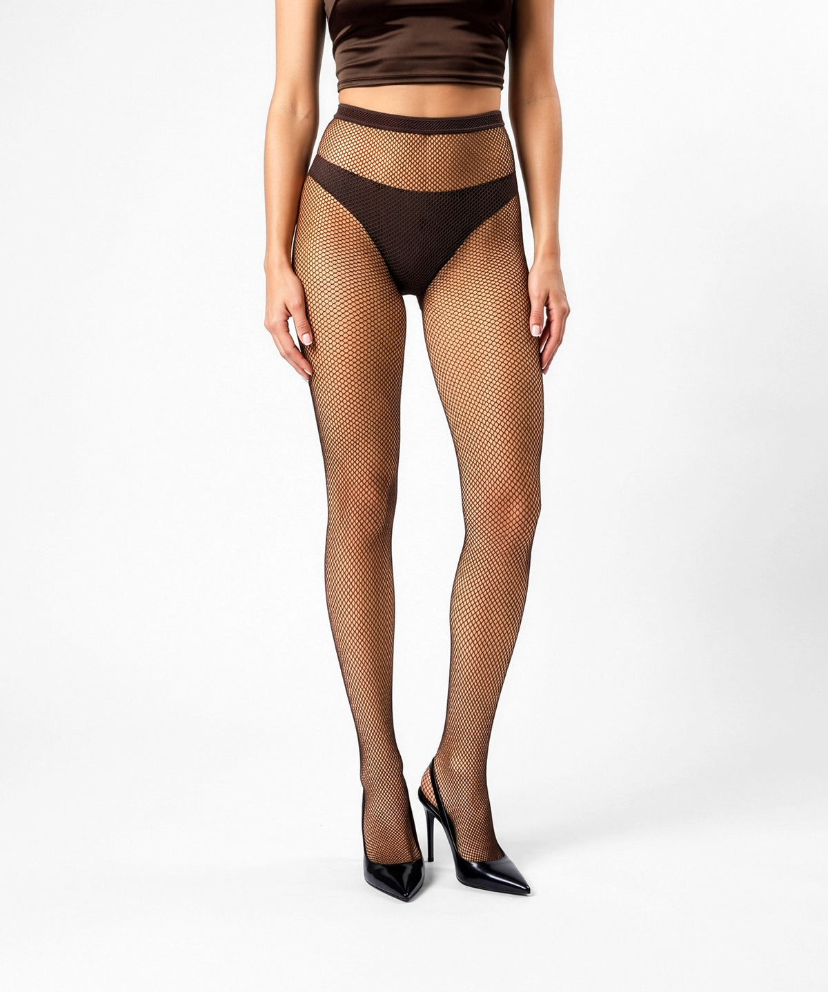 Dark brown fishnet tights and black high heels. Italian fishnet pantyhose in a dark chocolate or coffee shade. The fishnets feature a micro-net mesh suitable for all-season wear, from summer, fall, and winter to spring.